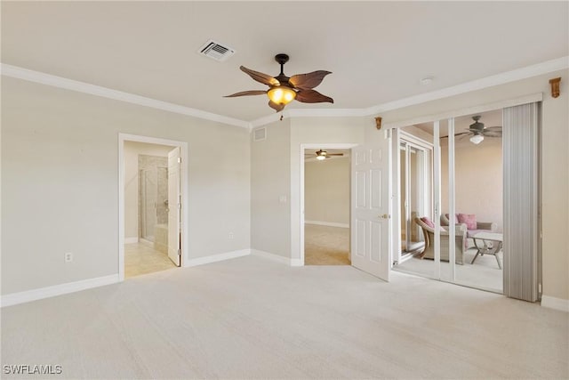 unfurnished bedroom with crown molding, light colored carpet, ceiling fan, and a closet