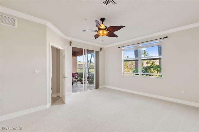 empty room featuring ornamental molding, carpet flooring, and ceiling fan