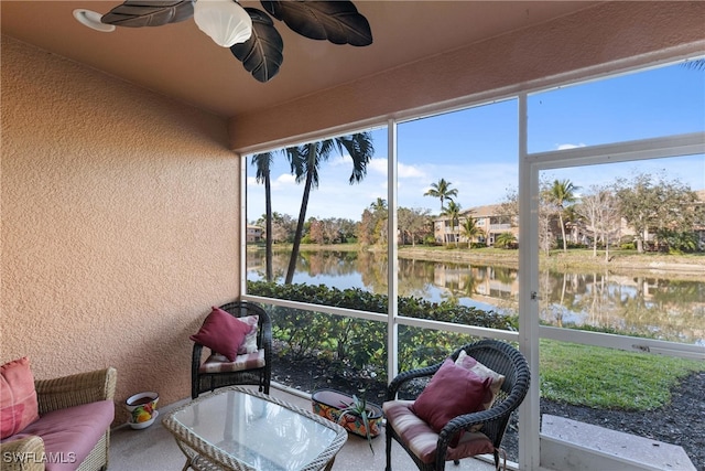 sunroom / solarium featuring a water view