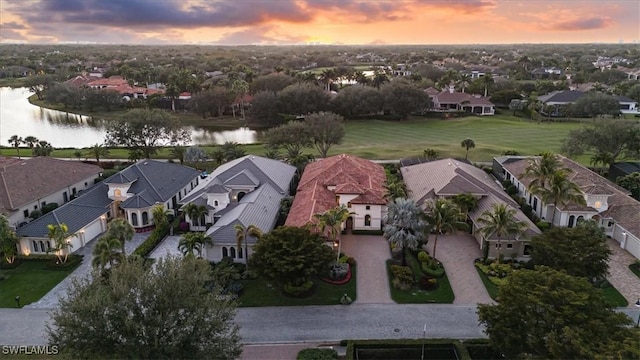 aerial view at dusk with a water view