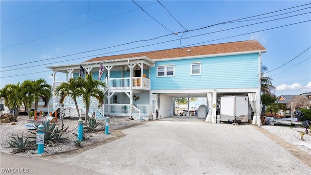 view of front facade featuring a carport and a balcony