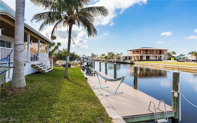 view of dock with a water view and a yard