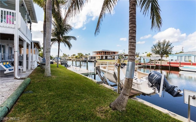 dock area featuring a water view and a yard