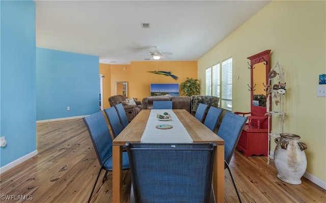 dining area with hardwood / wood-style floors and ceiling fan