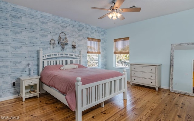 bedroom with light hardwood / wood-style flooring and ceiling fan