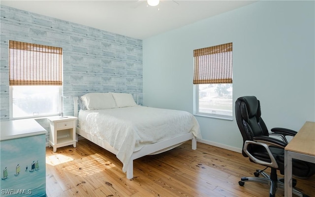 bedroom with ceiling fan and light hardwood / wood-style flooring