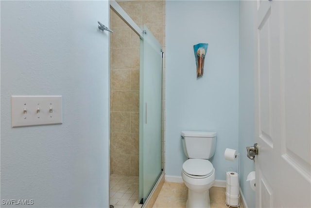 bathroom with a shower with shower door, tile patterned floors, and toilet