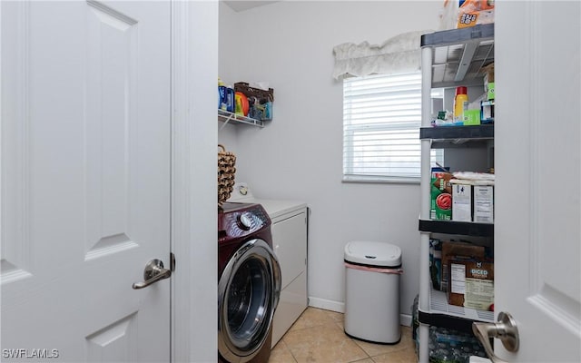 washroom with independent washer and dryer and light tile patterned floors