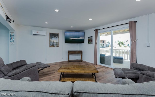 living room featuring light wood-type flooring and an AC wall unit