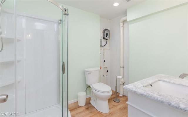 bathroom with vanity, hardwood / wood-style flooring, toilet, and walk in shower