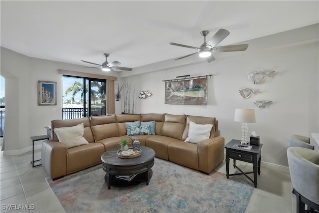 living room featuring light tile patterned floors and ceiling fan