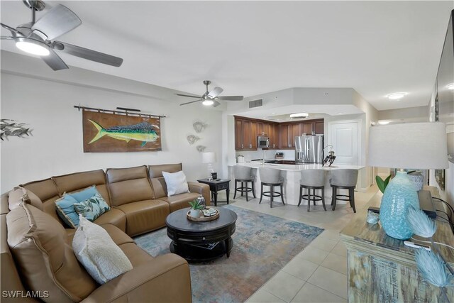 tiled living room featuring ceiling fan