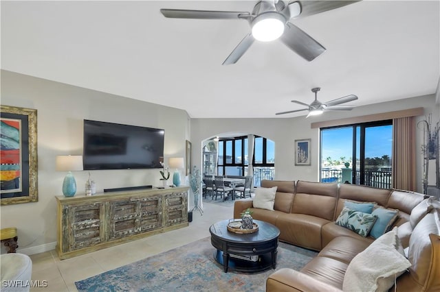 tiled living room featuring ceiling fan