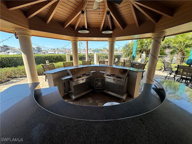 view of patio / terrace featuring a gazebo, exterior bar, area for grilling, and ceiling fan