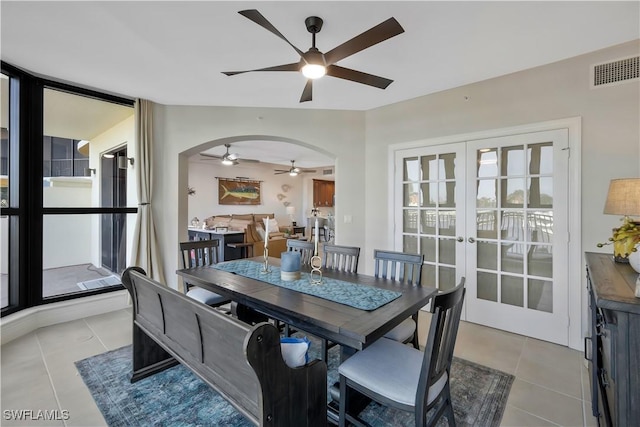 dining area with french doors, ceiling fan, and light tile patterned flooring