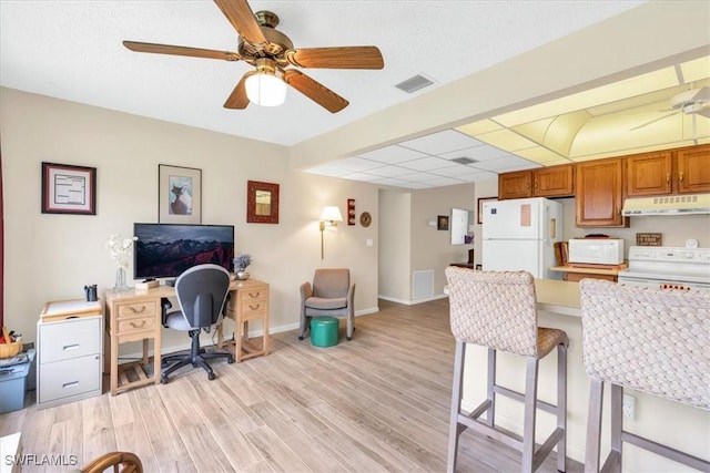 home office featuring light hardwood / wood-style flooring and ceiling fan