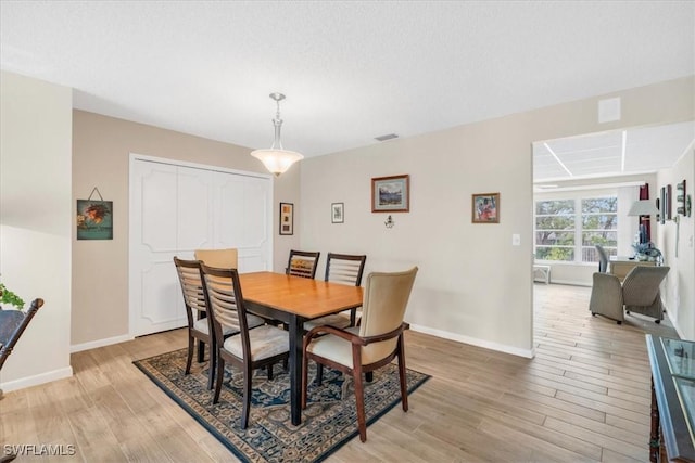 dining area with light hardwood / wood-style floors