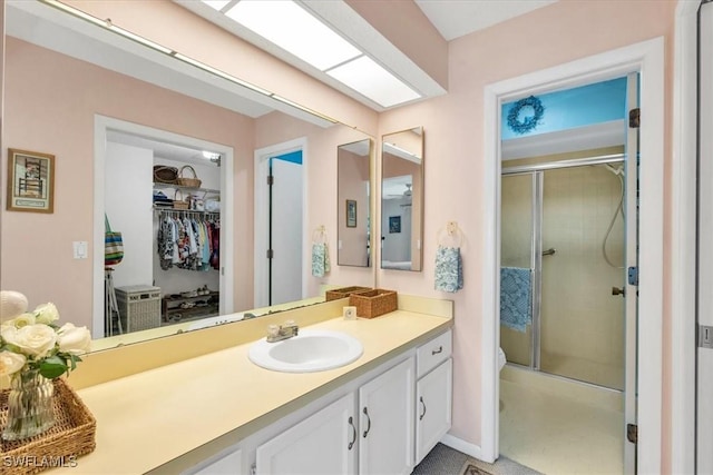 bathroom with vanity and a shower with shower door