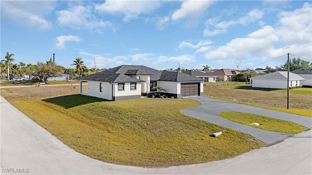 view of front of home with a garage and a front yard