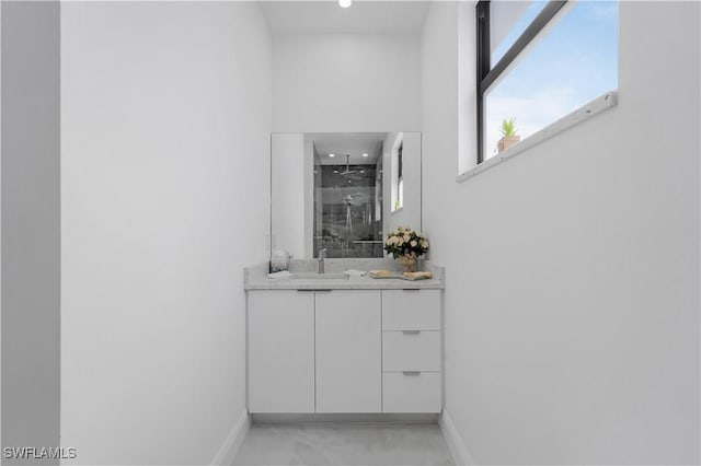 bathroom with vanity and a shower with door