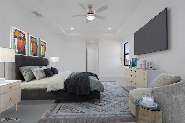 bedroom featuring a raised ceiling and ceiling fan