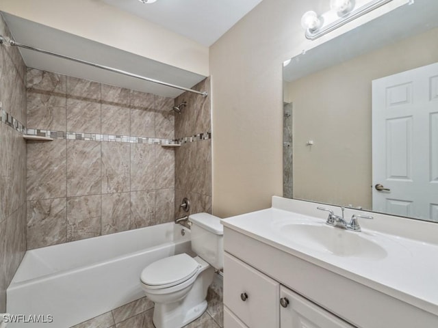 full bathroom featuring vanity, tile patterned floors, toilet, and tiled shower / bath