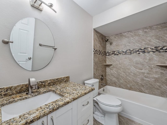 full bathroom featuring vanity, tiled shower / bath combo, and toilet