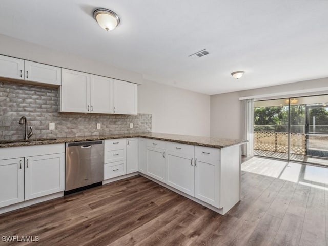 kitchen featuring sink, stainless steel dishwasher, white cabinets, and kitchen peninsula