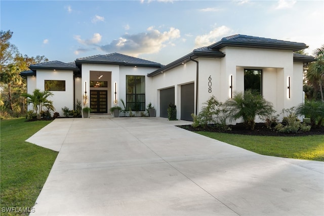 view of front facade featuring a garage and a front yard