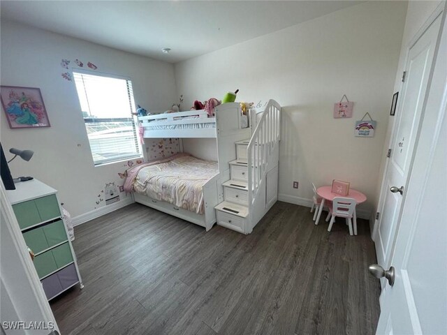 bedroom with dark wood-type flooring