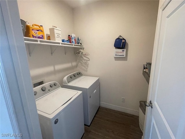 laundry area with dark wood-type flooring and washing machine and dryer