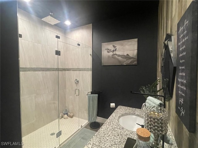 bathroom featuring vanity and a shower with shower door