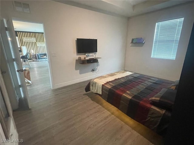 bedroom with dark hardwood / wood-style floors