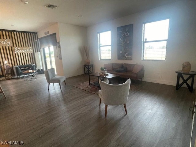 living room with dark wood-type flooring and a wealth of natural light