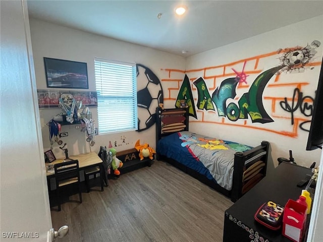 bedroom with hardwood / wood-style flooring