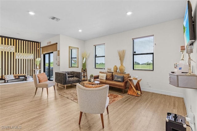 living area with recessed lighting, visible vents, and light wood-style floors