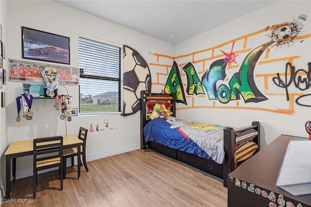 bedroom featuring baseboards and wood finished floors