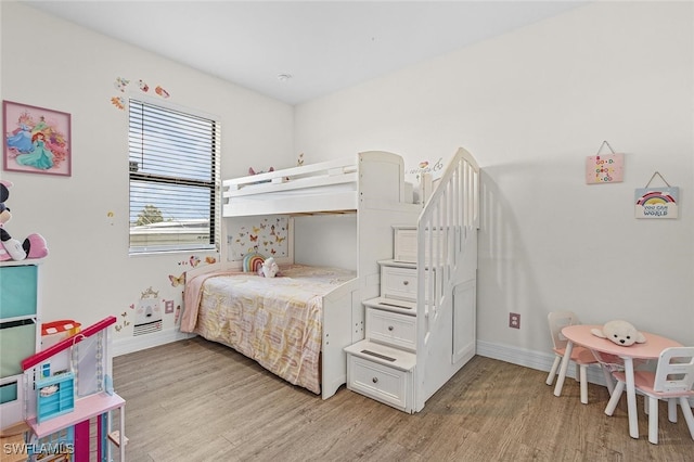 bedroom featuring baseboards and light wood-type flooring