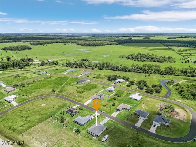 birds eye view of property with a rural view