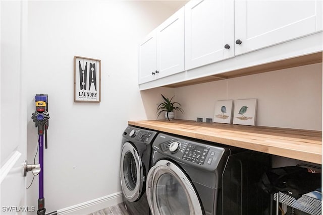 laundry room with cabinets and separate washer and dryer