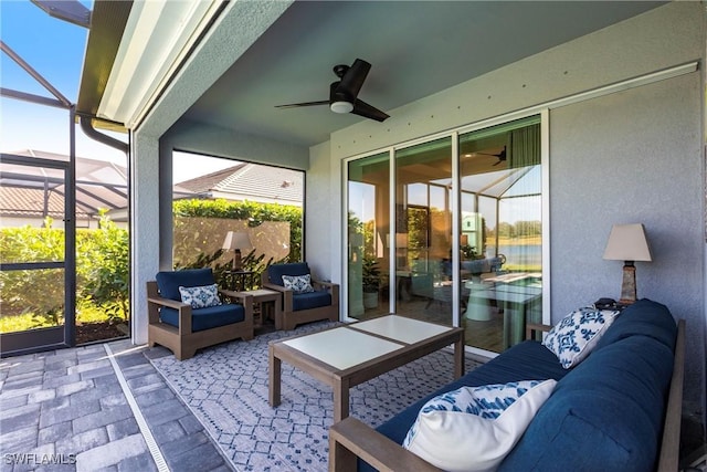 sunroom featuring a healthy amount of sunlight and ceiling fan