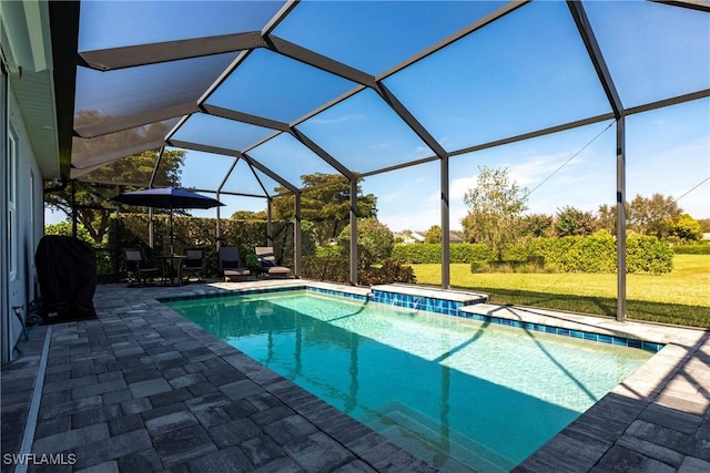 view of pool featuring a grill, a patio, and glass enclosure