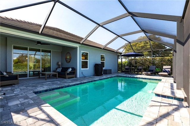 view of swimming pool with a fenced in pool, a patio, outdoor lounge area, a ceiling fan, and a lanai