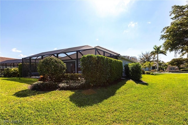 view of yard featuring glass enclosure