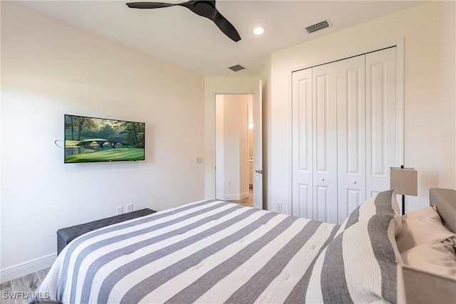 bedroom featuring baseboards, ceiling fan, visible vents, and a closet