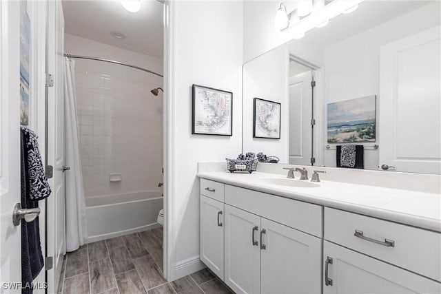 bathroom featuring toilet, wood finish floors, vanity, and shower / bathtub combination with curtain