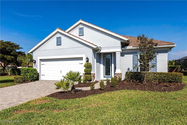 ranch-style home featuring an attached garage, stucco siding, decorative driveway, and a front yard