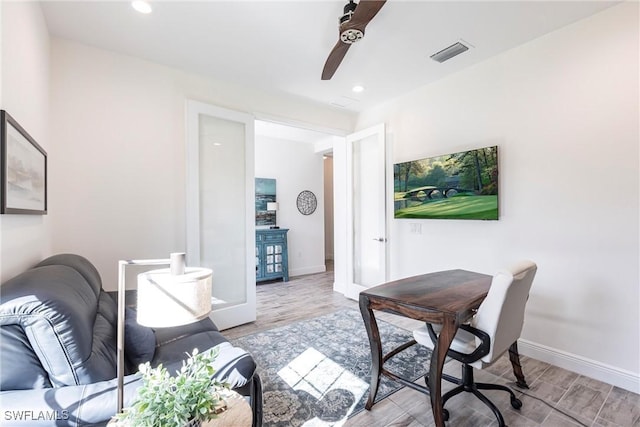 office space with recessed lighting, visible vents, light wood finished floors, and baseboards