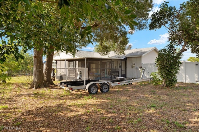 back of property with a sunroom