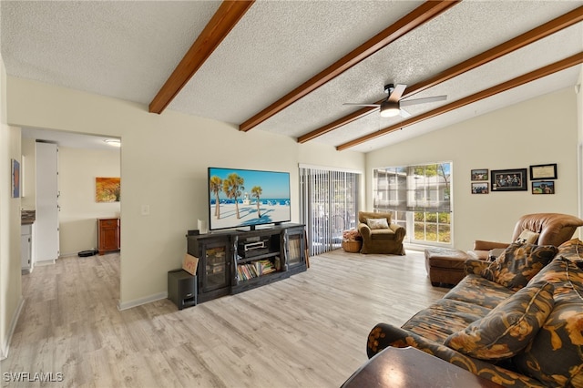 living room featuring lofted ceiling with beams, ceiling fan, a textured ceiling, and light hardwood / wood-style flooring